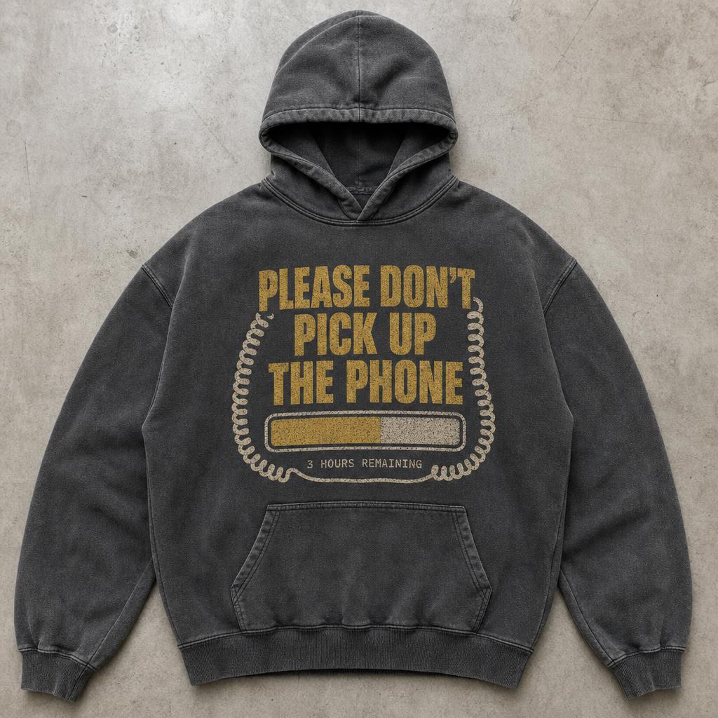 Washed charcoal hoodie printed in muted gold with please don't pick up the phone above a blocky progress bar framed by a coiled phone cord