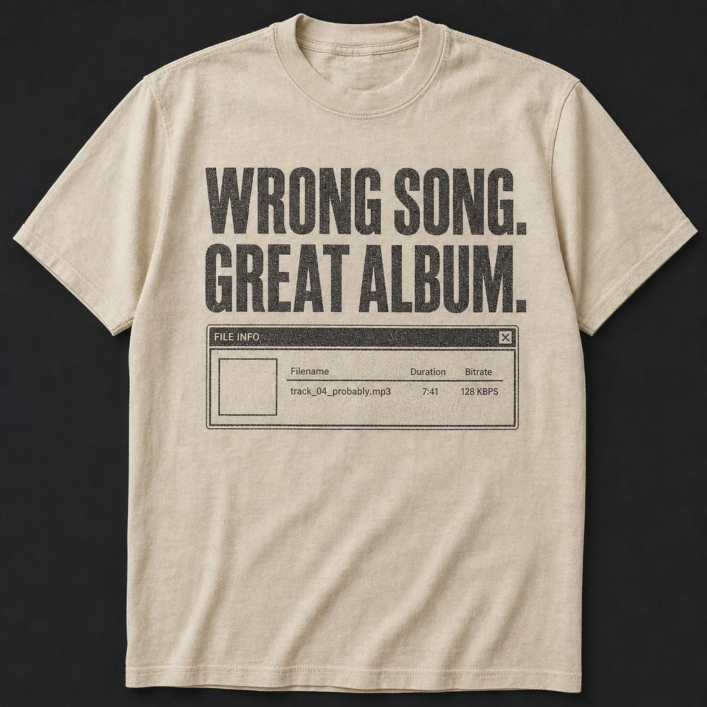 Cream t-shirt printed with bold type reading wrong song great album above a plain retro file info window